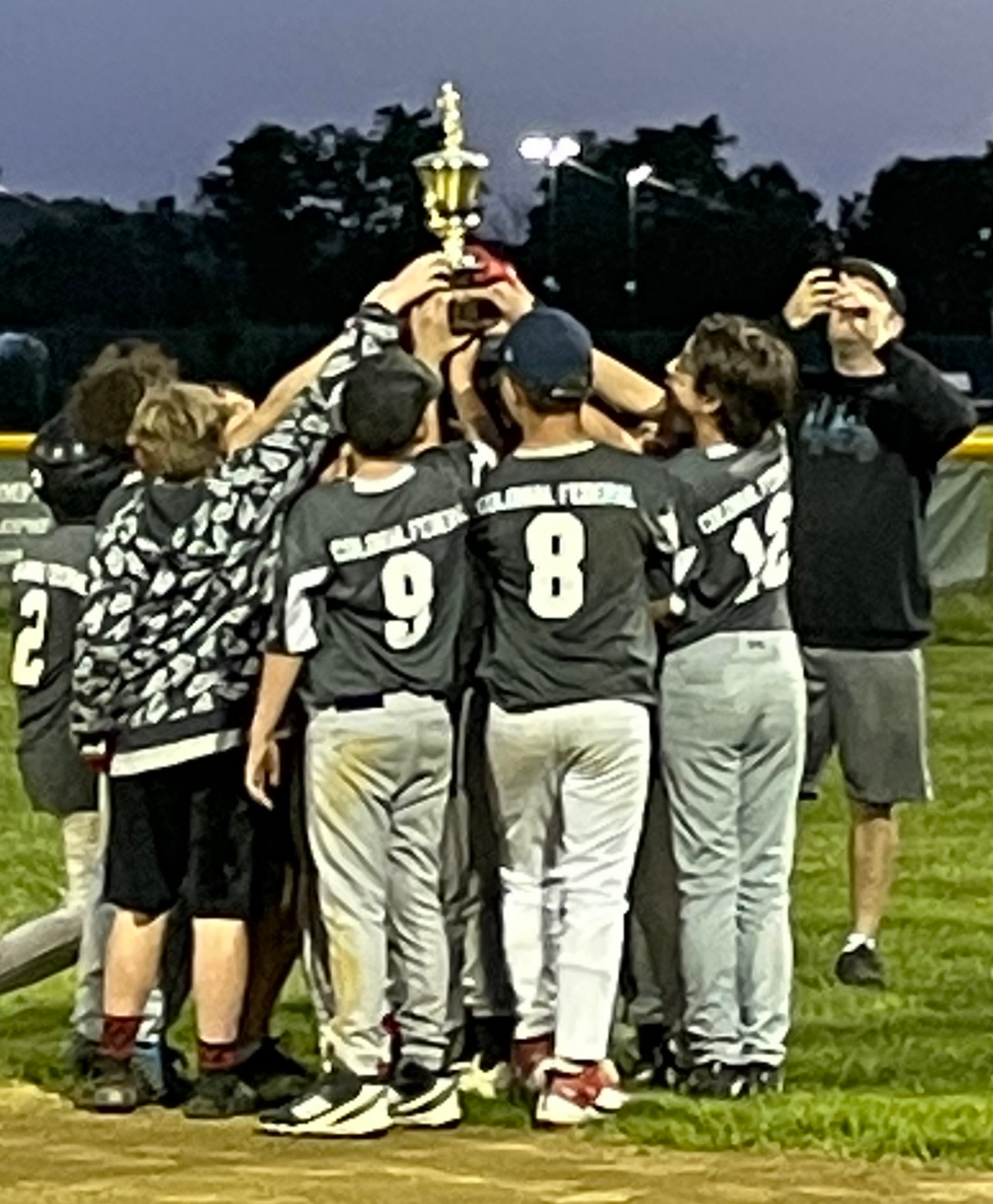 Team holding up their trophy.